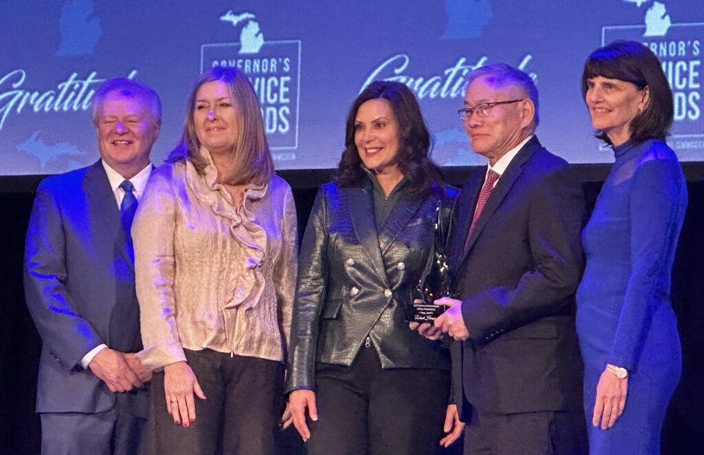 Roland receives the 2023 Humanitarian award from MI Governor Whitmer.